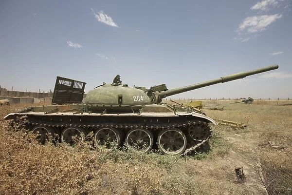 A Russian T-62 main battle tank rests in an armor junkyard