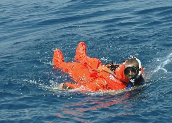 A Sailor rescued by a diver