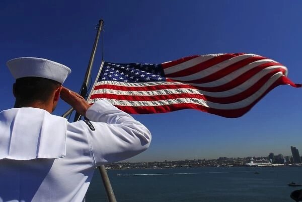 A sailor salutes the American flag