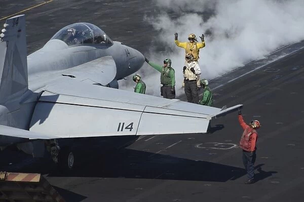 Sailors prepare an F  /  A-18F Super Hornet for launch