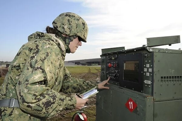 Seabee completes a generator check during a Command Post Exercise