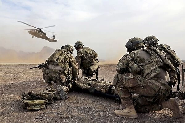Security force team members wait for a UH-60 Blackhawk medevac helicopter