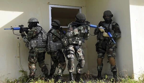 Security Forces members perform a quick check before entering a house