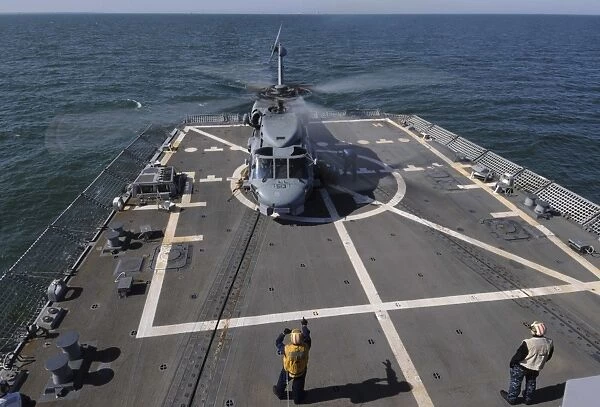 An SH-60B Sea Hawk lands on the flight deck of USS Forrest Sherman