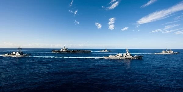 Ships from the John C. Stennis Carrier Strike Group transit the Pacific Ocean