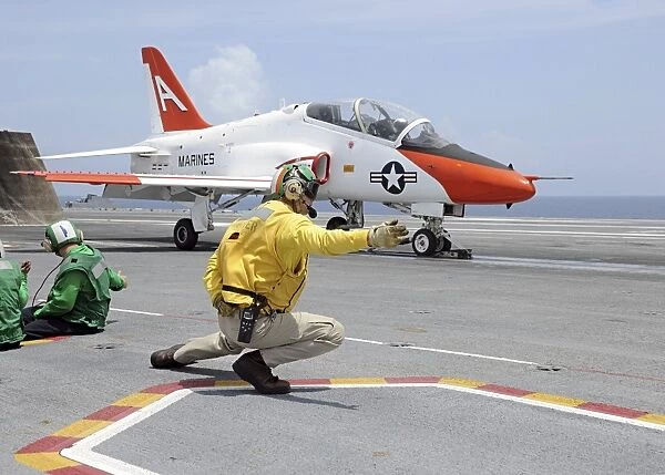 A shooter aboard the aircraft carrier USS George H