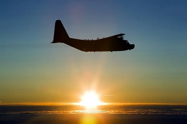 Silhouette of a MC-130H Combat Talon against a setting sun over East Anglia, UK