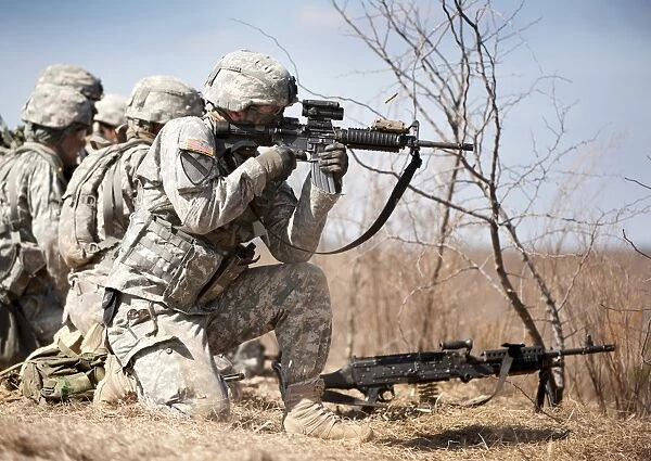 Soldier fires his rifle at a target