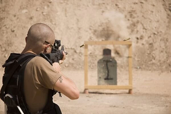 A soldier fires three round bursts from a M4 carbine assault rifle