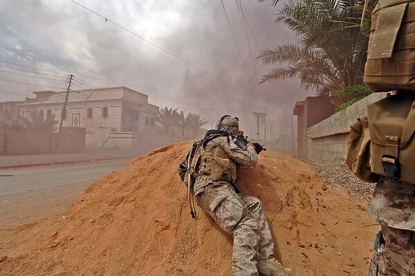 A soldier lays down a vicious barrage of gun fire on insurgent positions