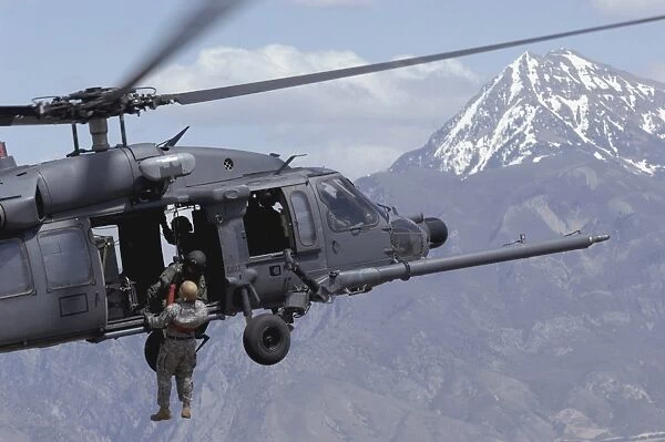 A soldier is lifted on board an Air Force HH-60 Pave Hawk