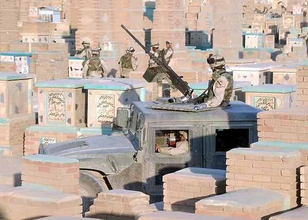 A soldier mans a M2. 50 caliber machine gun atop a humvee