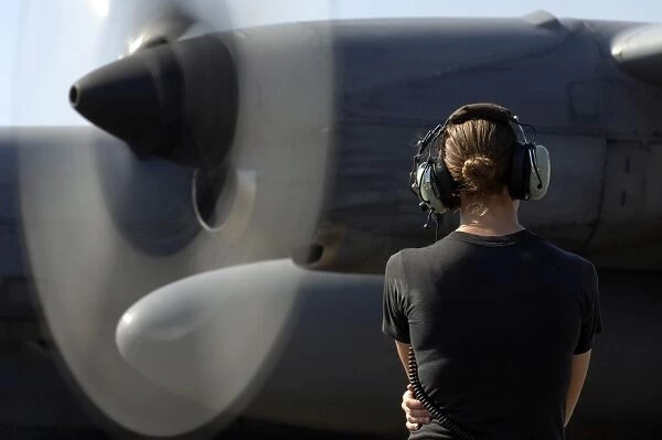 A soldier monitors the performance of a newly repaired C-130 Hercules engine