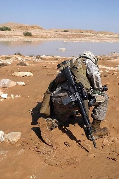 Soldier patrols along a riverbed on a search and rescue mission
