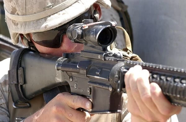 Soldier peers through his sights as he maintains security