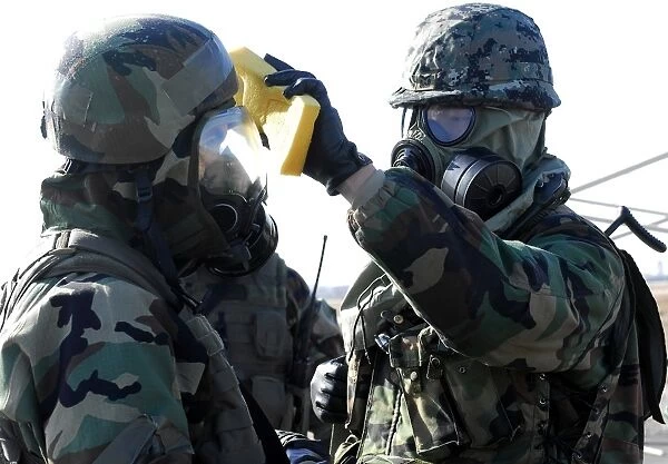 Soldiers help each other during a decontamination process