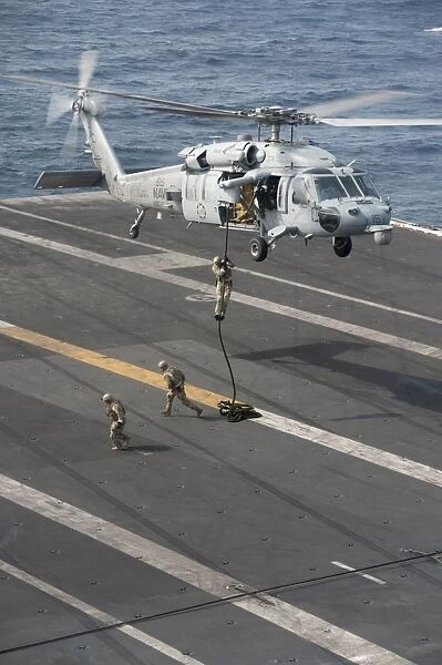 Soldiers rappel from an MH-60S Sea Hawk helicopter