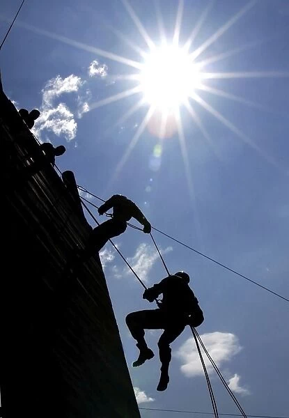 Soldiers rappell from a 70-foot tower
