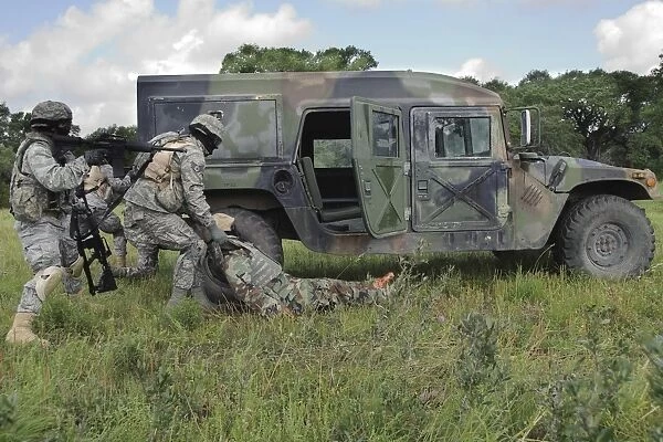 Soldiers recover the victim of a simulated roadside bomb