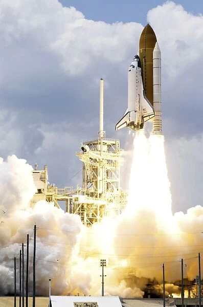 Space Shuttle Atlantis lifts off from its launch pad toward Earth orbit