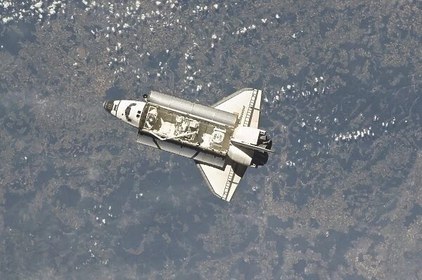 Space shuttle Endeavour backdropped by a colorful Earth