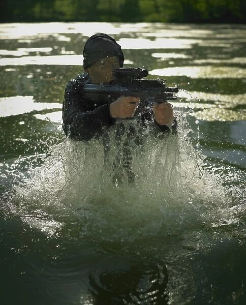 Special operations forces soldier emerges from water armed with a Steyr AUG assault rifle