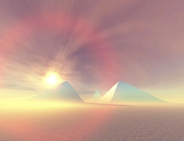 The sun rises on Egyptian pyramids on a desert morning