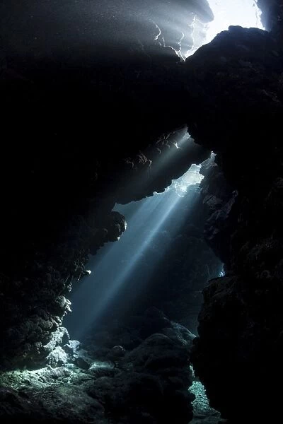 Sunlight descends underwater and into a crevice in a reef in the Solomon Islands