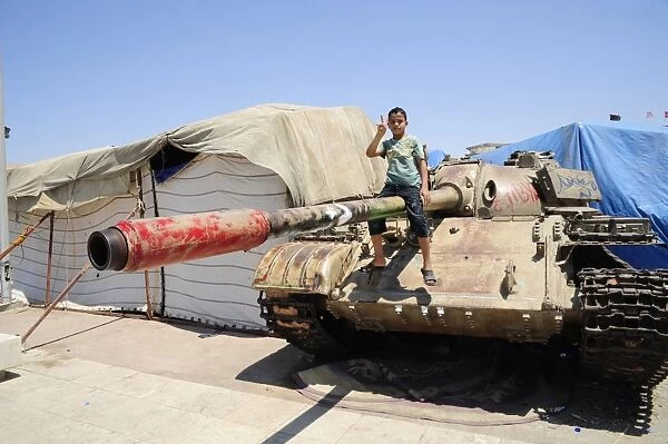A T-55 tank with two children playing on it in Benghazi, Libya