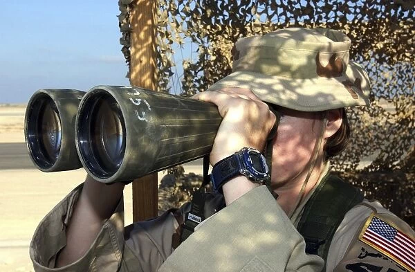 U. S. Air Force Airman looks through a set of binoculars