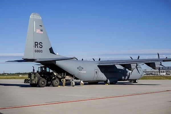 A U. S. Air Force C-130J Super Hercules is being unloaded