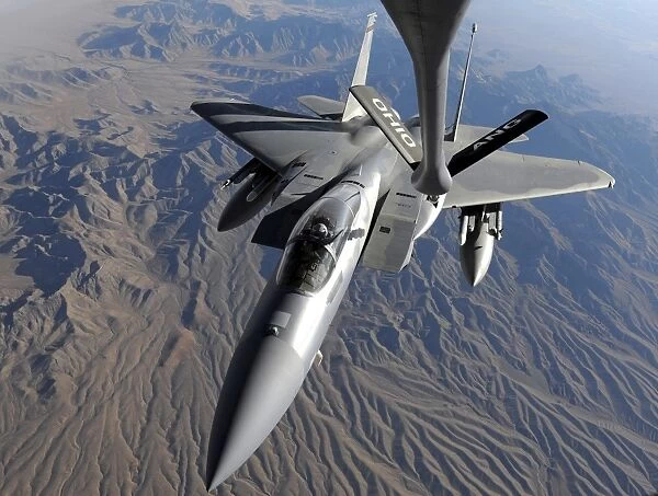 A U. S. Air Force F-15 Eagle flies toward the boom of a KC-135 Stratotanker