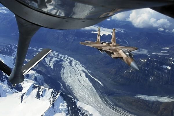 A U. S. Air Force F-15C Eagle positioning itself behind a KC-135R Stratotanker over Alaska