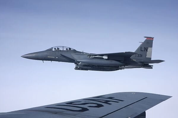 U. S. Air Force F-15E Strike Eagle over the wing of a KC-135 Stratotanker