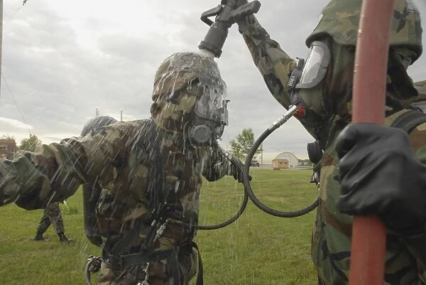 U. S. Air Force Soldier decontaminates an Airman