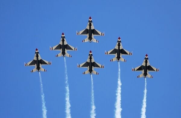 The U. S. Air Force Thunderbirds perform a 6-ship formation flyby during an air show