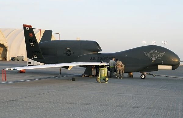 U. S. Airmen conduct preflight services on an RQ-4 Global Hawk