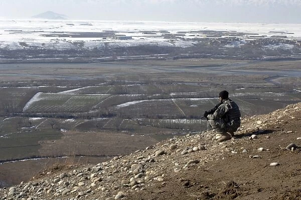 U. S. Army Soldier looks out over the village of Dingak, Afghanistan