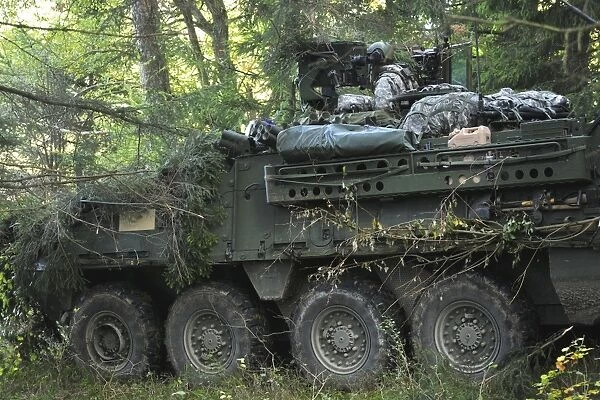 A U. S. Army soldier pulls security in a Stryker armored vehicle