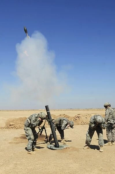 U. S. Army soldiers firing an M120 120mm mortar system in Mahmadiyah, Iraq
