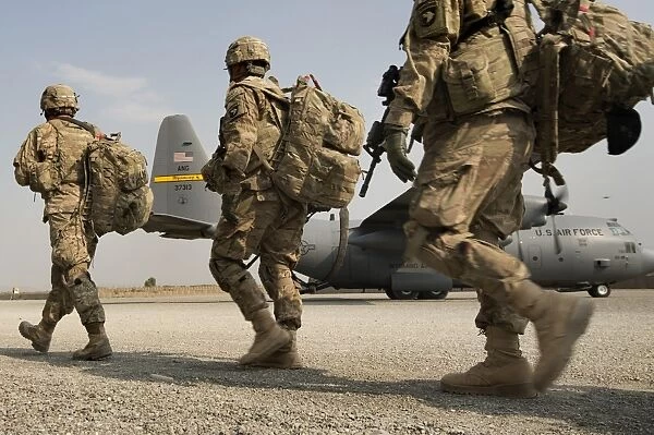 U. S. Army soldiers make their way to a C-130 Hercules