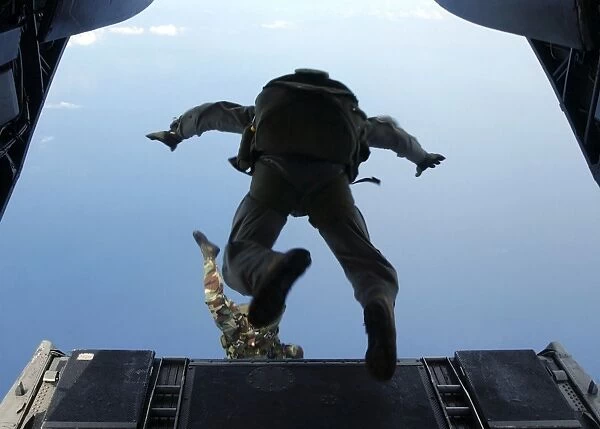 U. S. Army soldiers perform HALO jumps out of a CH-46E Sea Knight helicopter