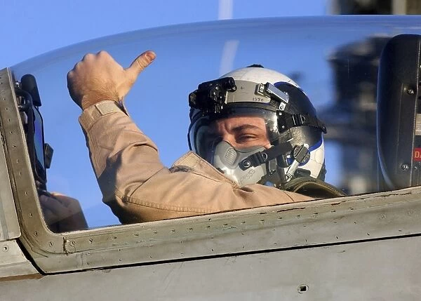 A U. S. Marine Corps pilot gives a thumbs-up signal prior to launching