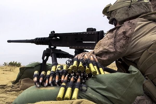 A U. S. Marine fires an M2. 50 caliber machine gun