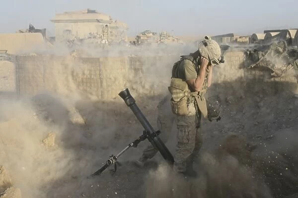 A U. S. Marine fires a mortar round during combat operations in Afghanistan
