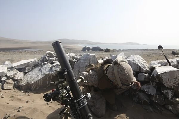 A U. S. Marine fires a mortar in Salinas, Peru
