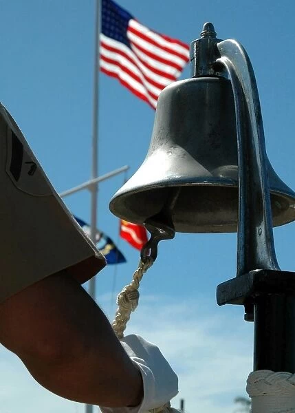 U. S. Marine sounds a bell honoring fallen Marines during a ceremony