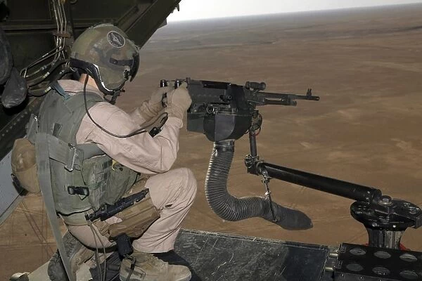 U. S. Marine test firing an M240 heavy machine gun on the back of a MV-22B Osprey