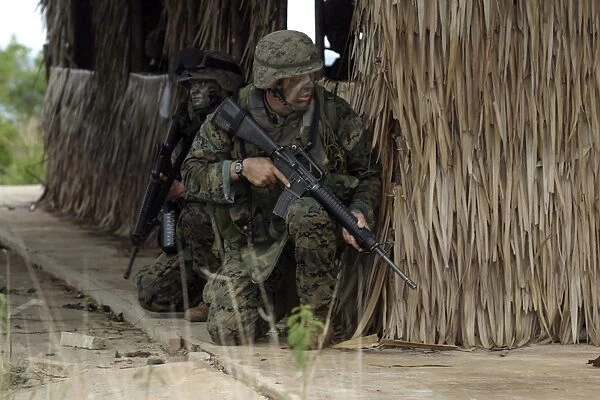 U. S. Marines prepare to enter a house during a raid