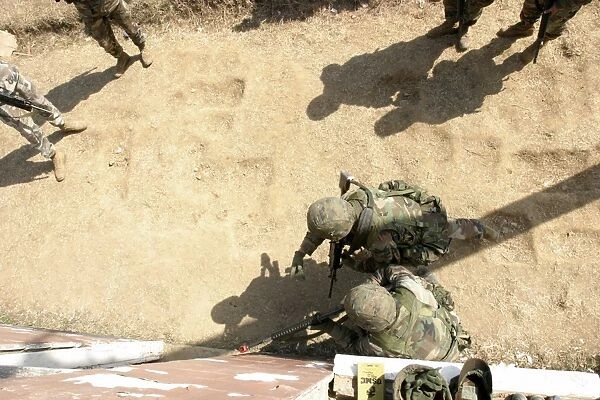 U. S. Marines throws a practice grenade into a room to clear it before they enter